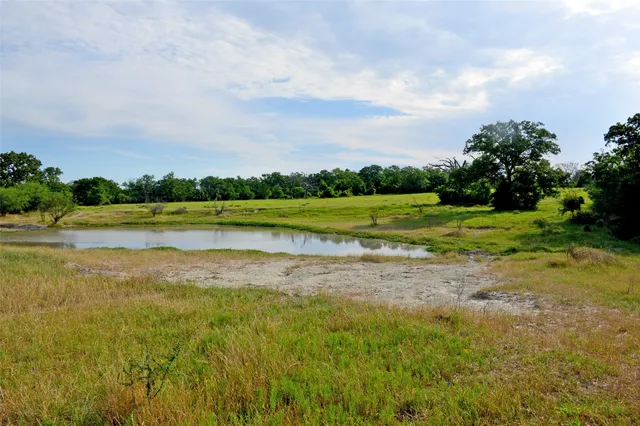 a view of a lake with houses in the back