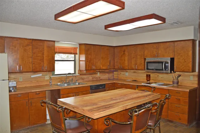 a kitchen with a stove a sink and a microwave