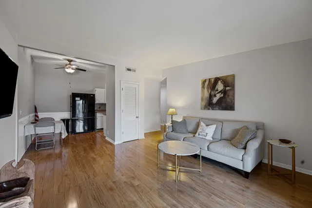 a living room with furniture and a wooden floor
