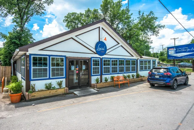 a view of a cafe with sitting area