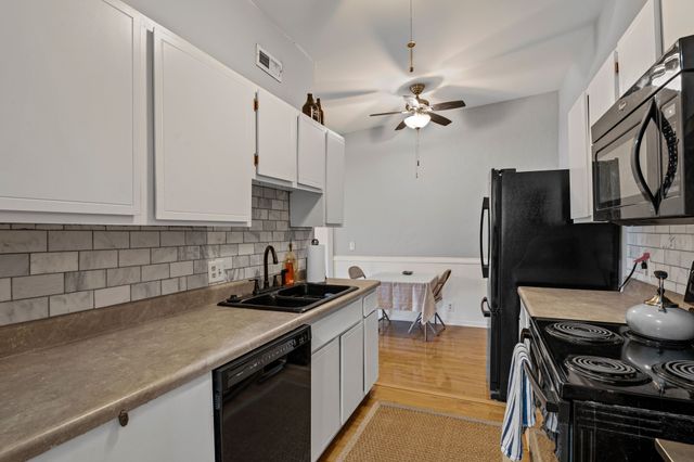 a kitchen with a sink a stove and refrigerator