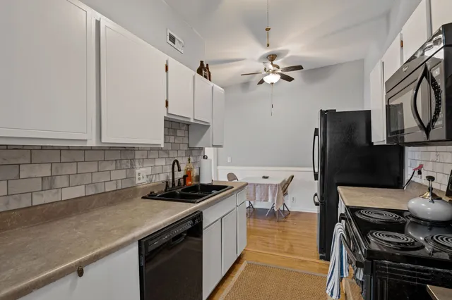 a kitchen with a sink a stove and refrigerator