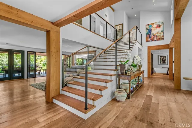 a view of entryway and hall with wooden floor