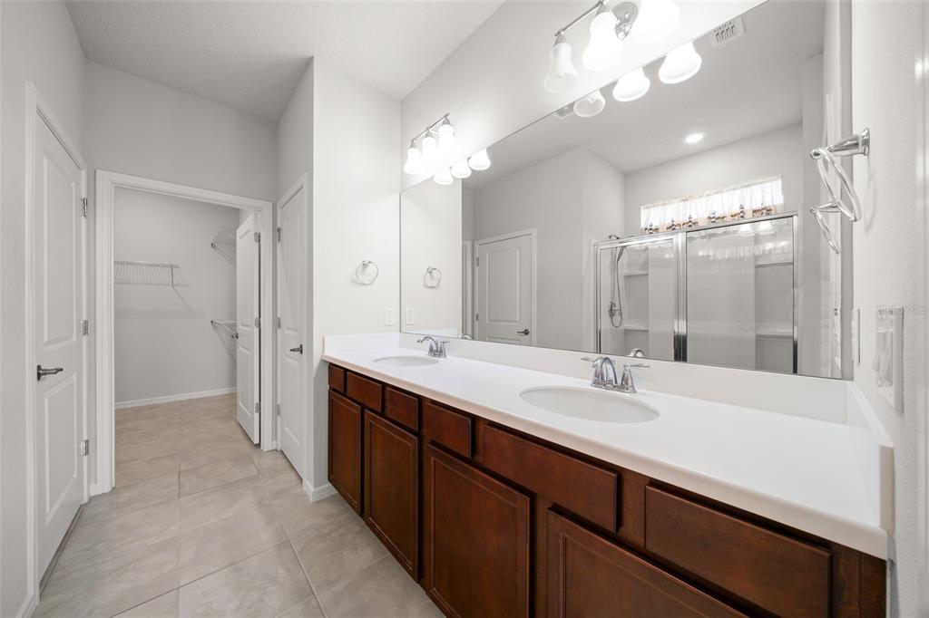 5947 Southwest 93rd Circle Ocala, FL 34481 - Photo 14 of 32 a bathroom with a sink a double vanity and a mirror