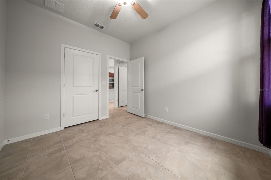 5947 Southwest 93rd Circle Ocala, FL 34481 - Photo 17 of 32 an empty room with a ceiling fan