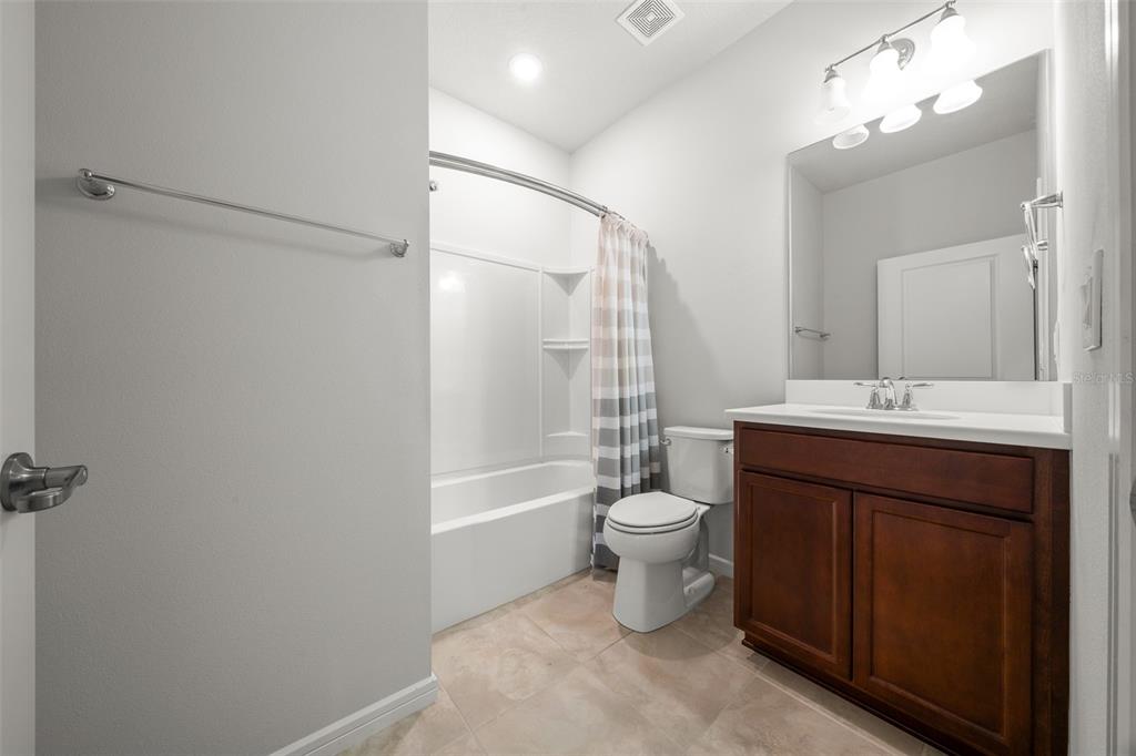 5947 Southwest 93rd Circle Ocala, FL 34481 - Photo 19 of 32 a bathroom with a sink vanity mirror and toilet