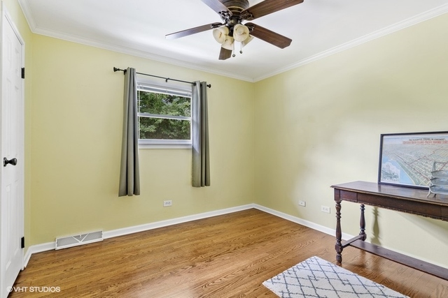 455 Elmhurst Road Mount Prospect, IL 60056 - Photo 11 of 19 a view of an empty room with window and wooden floor