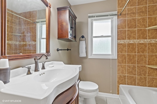 455 Elmhurst Road Mount Prospect, IL 60056 - Photo 12 of 19 a bathroom with a sink toilet and shower