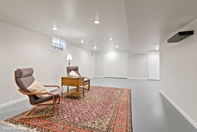 455 Elmhurst Road Mount Prospect, IL 60056 - Photo 14 of 19 a living room with a couch and a table