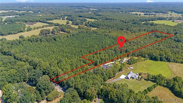 an aerial view of a houses with a yard