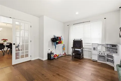 a view of a room with gym equipment and a flat screen tv