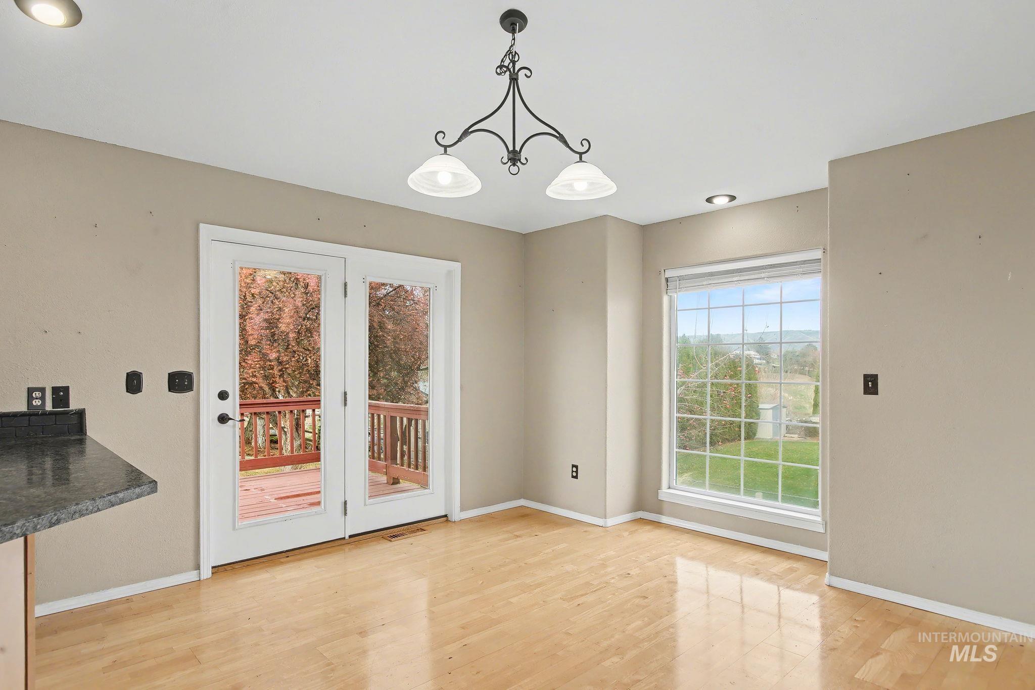 2242 Chukar Lane Clarkston, WA 99403 - Photo 14 of 41 Unfurnished dining area featuring recessed lighting, light wood-type flooring, and a chandelier