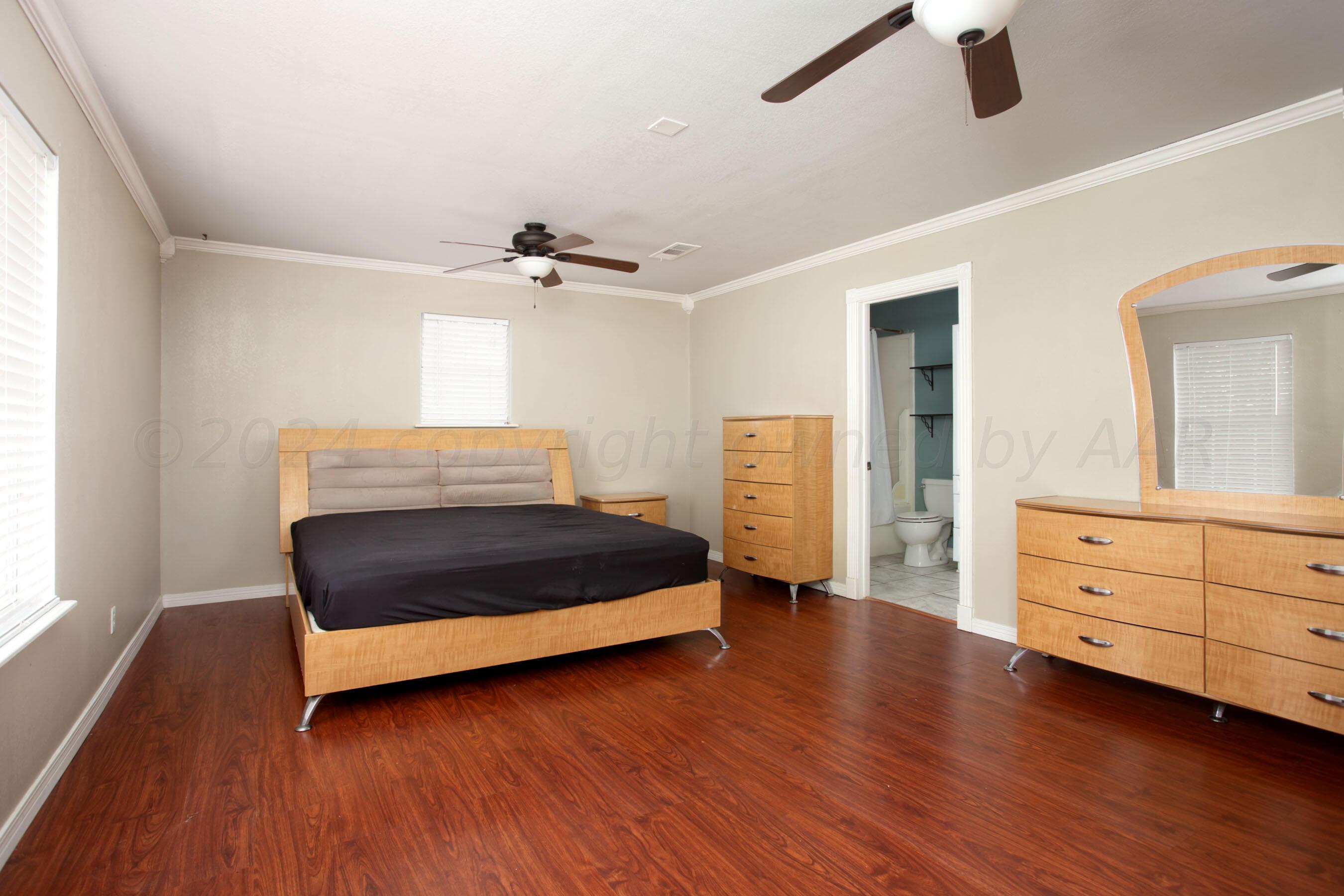 4205 South Ong Street Amarillo, TX 79110 - Photo 1 of 25 a bedroom with a bed and a dresser