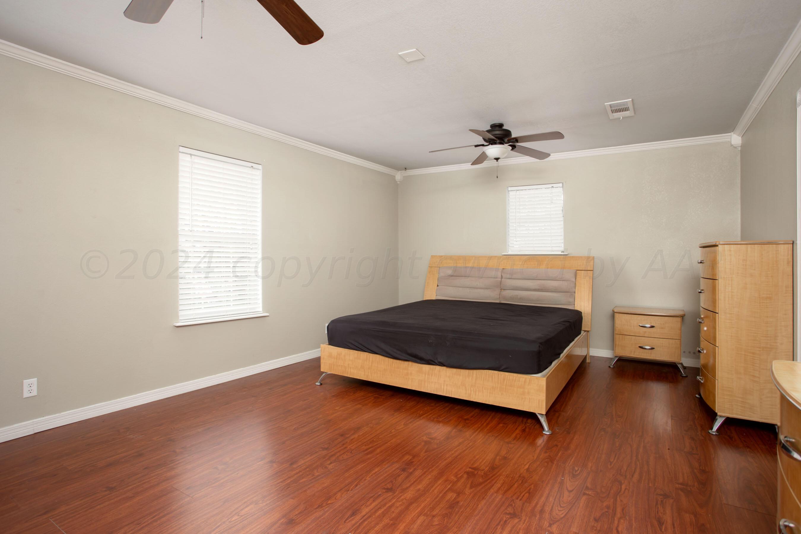 4205 South Ong Street Amarillo, TX 79110 - Photo 12 of 25 a bedroom with a bed and wooden floor