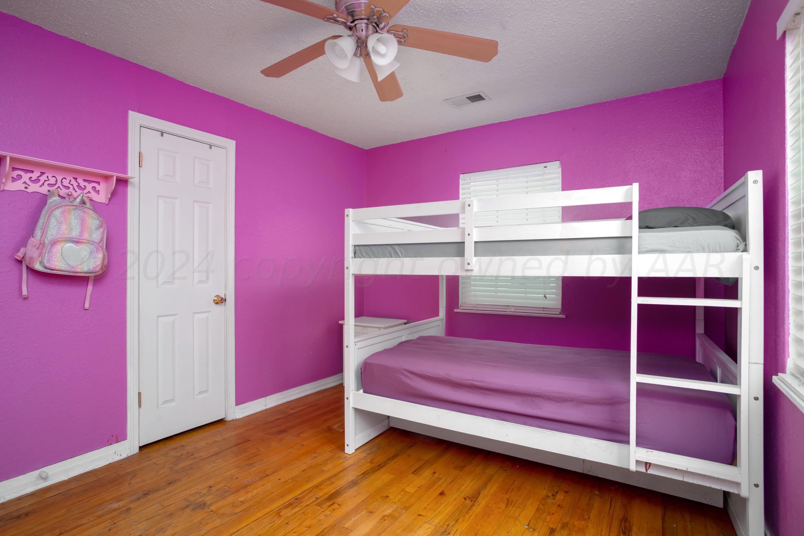 4205 South Ong Street Amarillo, TX 79110 - Photo 17 of 25 a bedroom with a bed and a chandelier