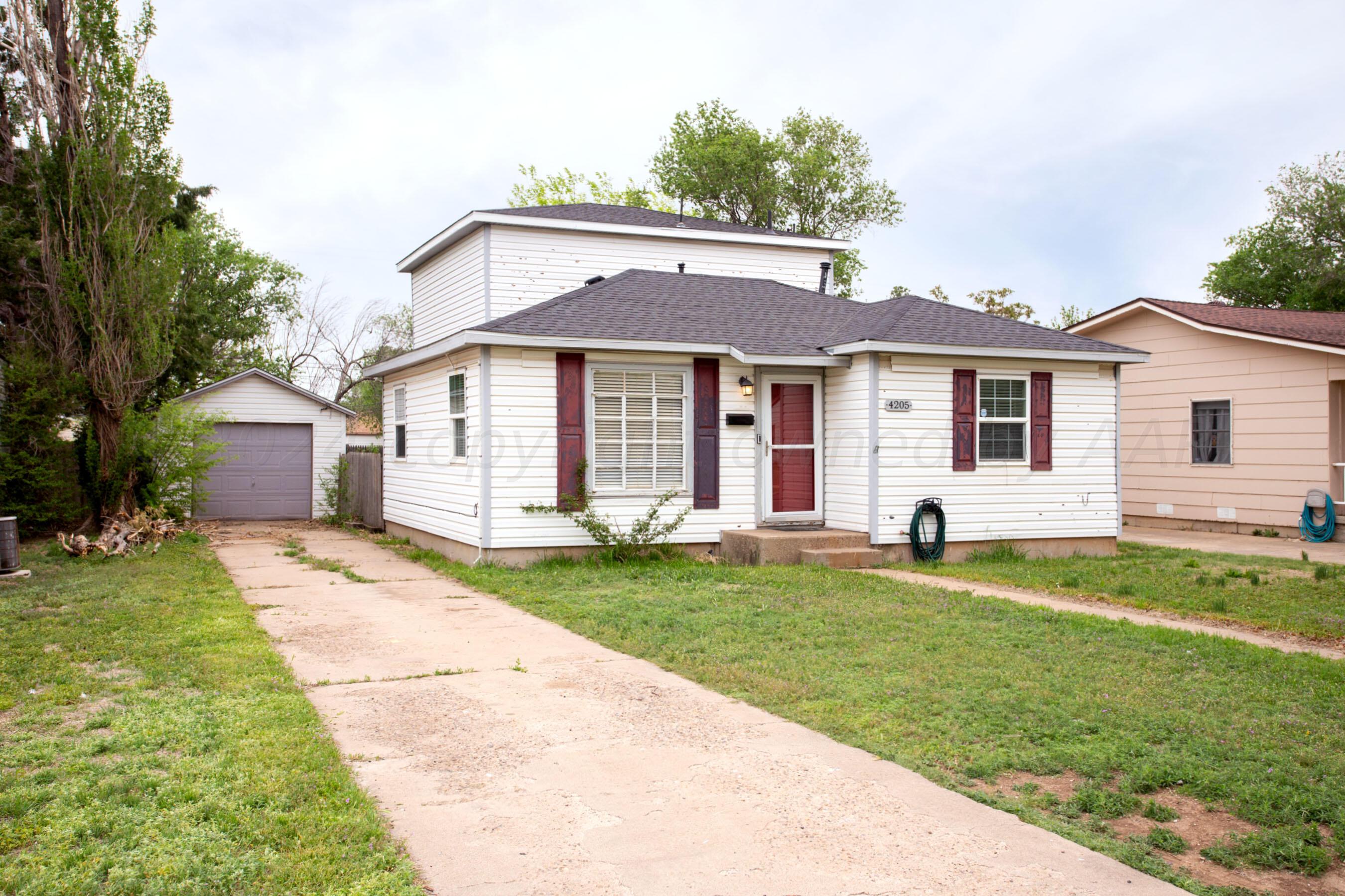 4205 South Ong Street Amarillo, TX 79110 - Photo 4 of 25 a front view of a house with a garden and yard