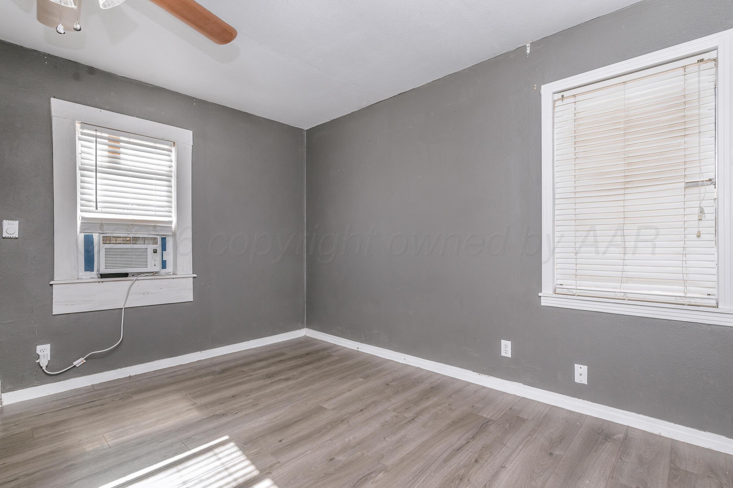 4429 Bowie Street Amarillo, TX 79110 - Photo 10 of 20 a view of wooden floor and windows in a room