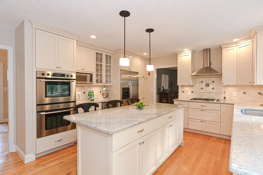 75 Alpine Drive Holliston, MA 01746 - Photo 11 of 42 a kitchen with stainless steel appliances kitchen island granite countertop a stove sink and cabinets