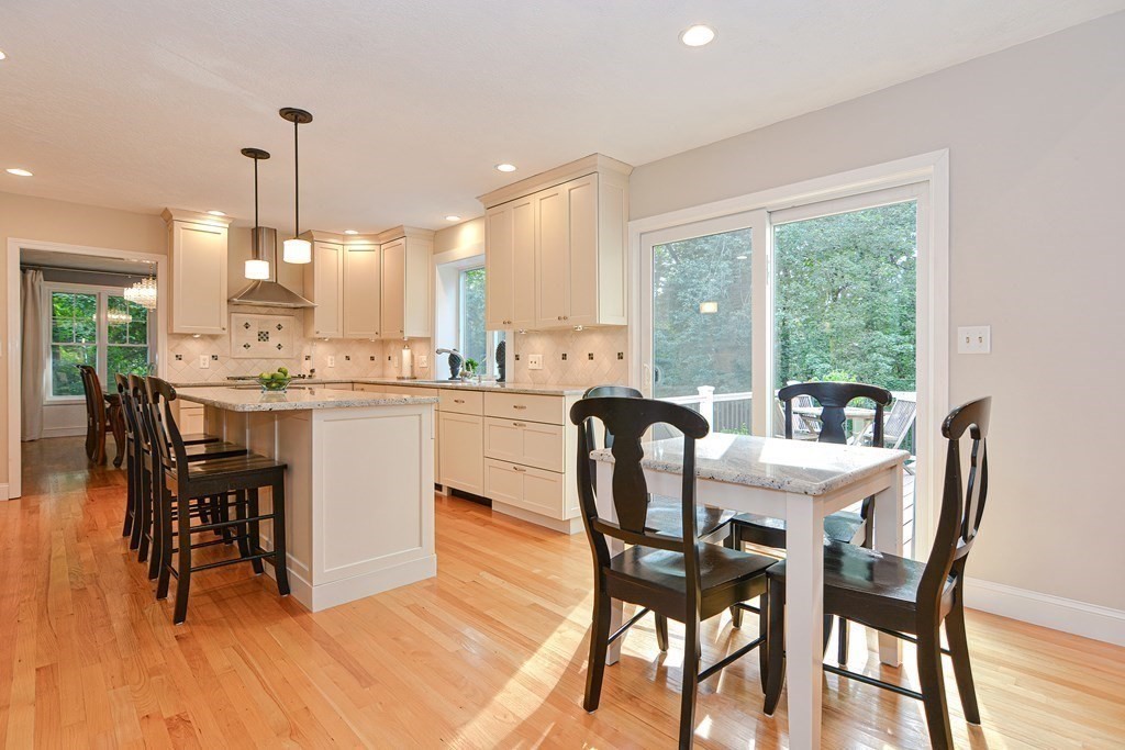75 Alpine Drive Holliston, MA 01746 - Photo 14 of 42 a dining room with a table chairs and a kitchen view