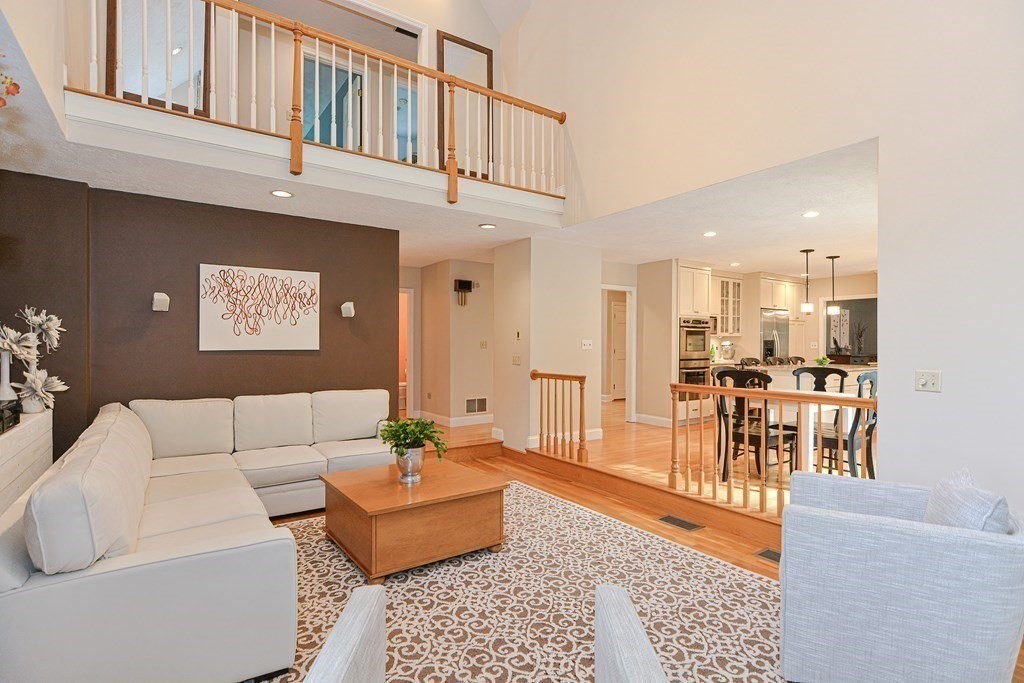 75 Alpine Drive Holliston, MA 01746 - Photo 15 of 42 a living room with furniture and a dining table with wooden floor