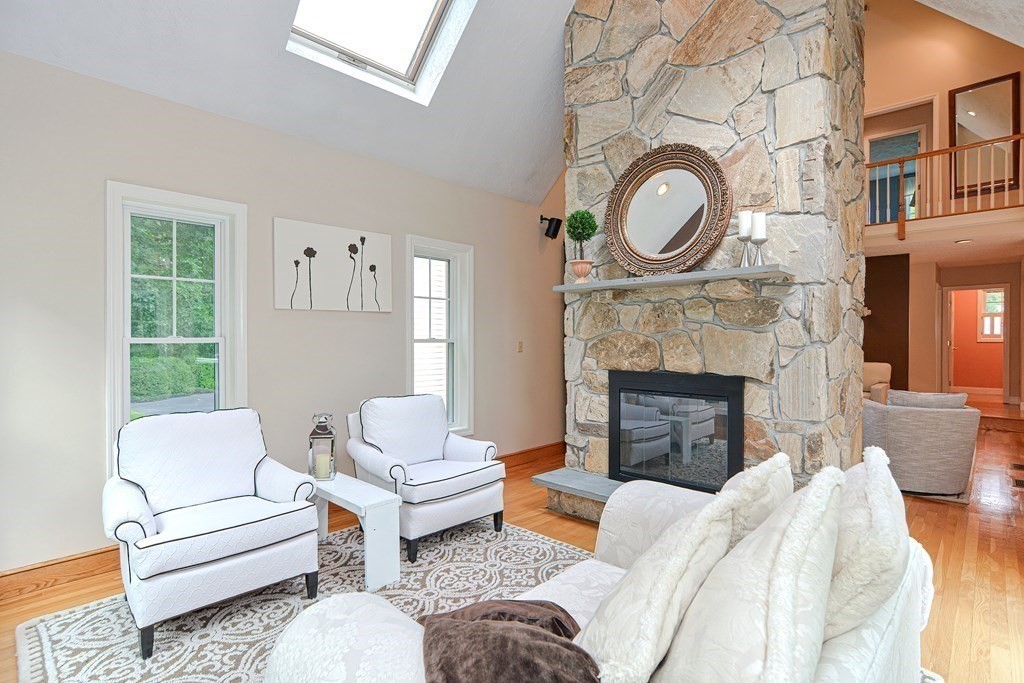 75 Alpine Drive Holliston, MA 01746 - Photo 17 of 42 a living room with furniture a large window and a fireplace