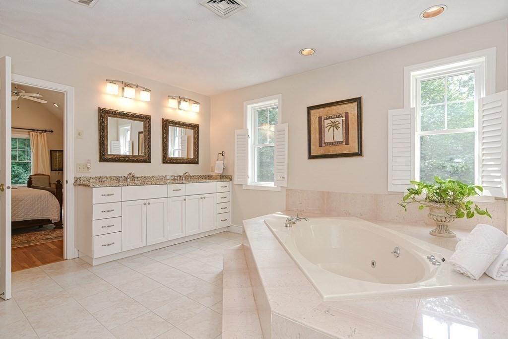 75 Alpine Drive Holliston, MA 01746 - Photo 27 of 42 a spacious bathroom with a granite countertop sink mirror and bathtub