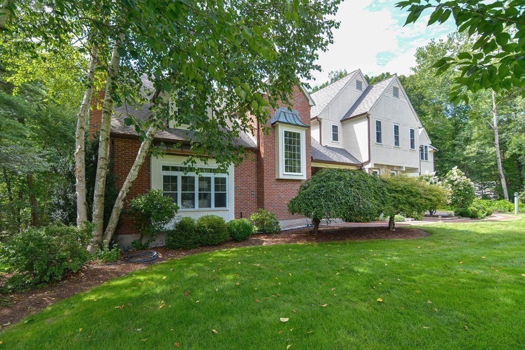 75 Alpine Drive Holliston, MA 01746 - Photo 42 of 42 a front view of a house with a garden and plants
