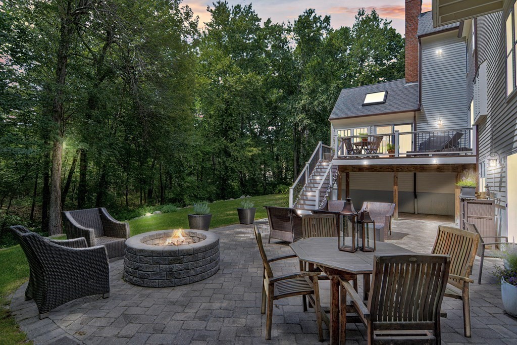 75 Alpine Drive Holliston, MA 01746 - Photo 5 of 42 a view of a patio with table and chairs potted plants and a palm tree
