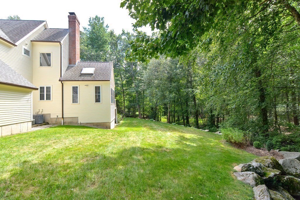 75 Alpine Drive Holliston, MA 01746 - Photo 8 of 42 a view of a house with a yard