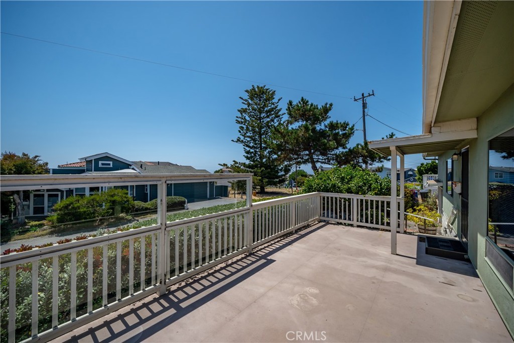 2275 Cass Avenue Cayucos, CA 93430 - Photo 15 of 60 a view of a house with a wooden deck and a floor to ceiling window