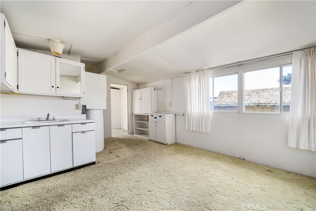 2275 Cass Avenue Cayucos, CA 93430 - Photo 56 of 60 a kitchen with white cabinets and white appliances