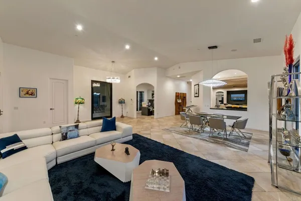 a kitchen with stainless steel appliances granite countertop a sink a stove counter space and chairs