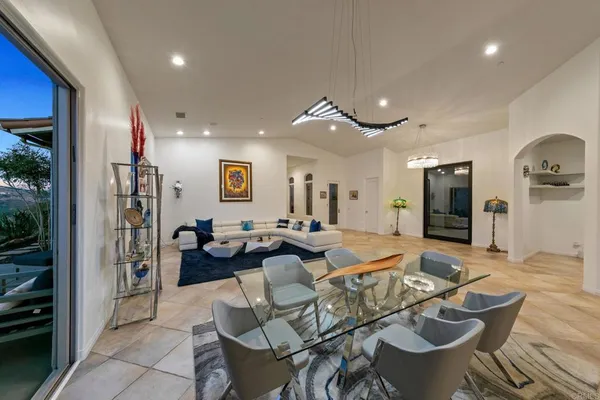 a kitchen with stainless steel appliances granite countertop a table and chairs
