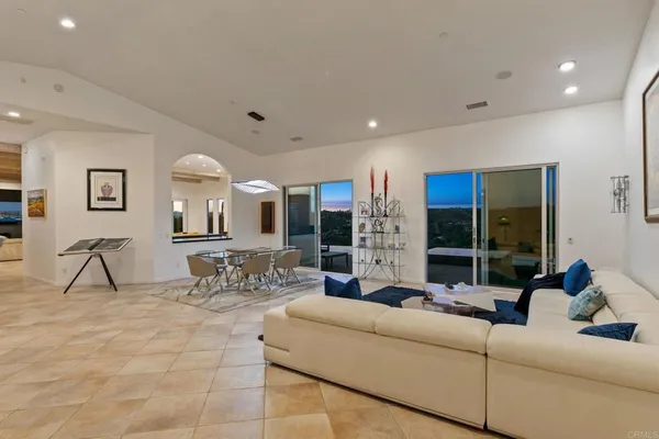 a living room with fireplace furniture and a large window