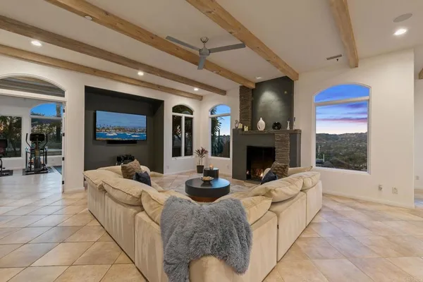 a spacious bedroom with a bed and a flat screen tv