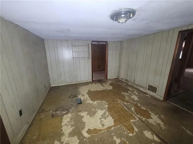 a view of a closet area with wooden floor