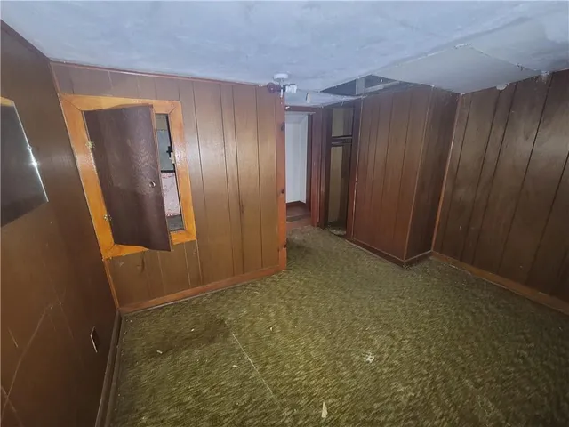 a view of entryway with wooden walls