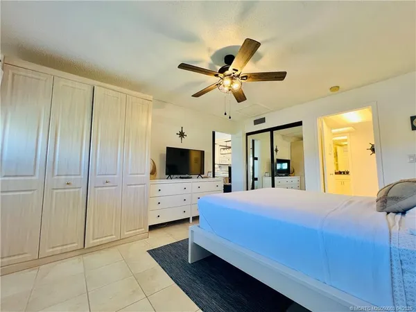 a bedroom with a bed and a tv