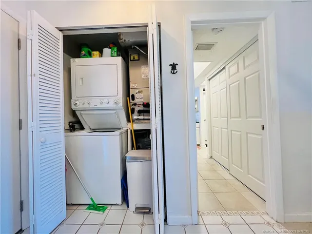 a view of a hallway with a refrigerator and a stove