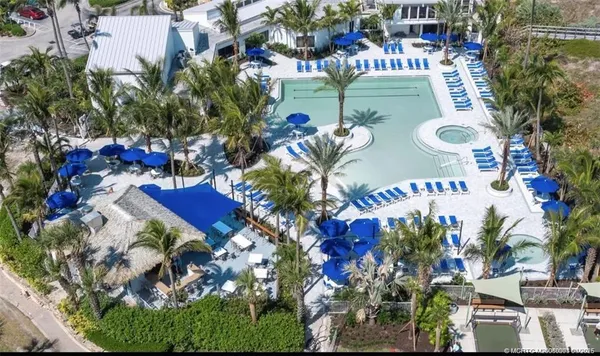 an aerial view of a house yard and swimming pool