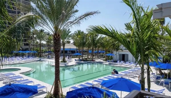 a swimming pool with outdoor seating and yard