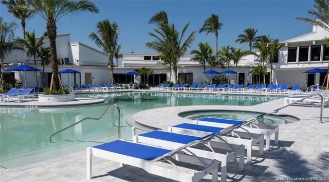 a front view of a house with swimming pool and glass windows