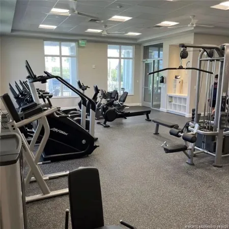 a room with gym equipment and a large window
