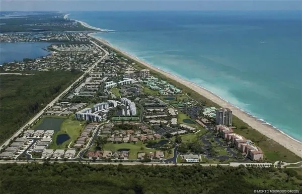 an aerial view of residential building and ocean