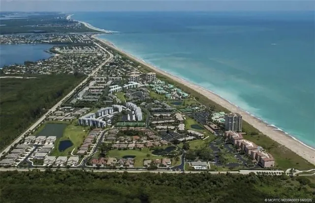 an aerial view of residential building and ocean