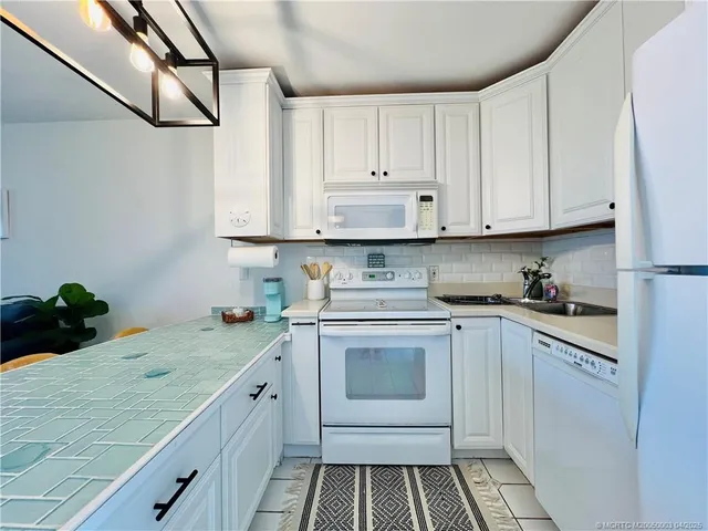 a kitchen with a sink stove and cabinets