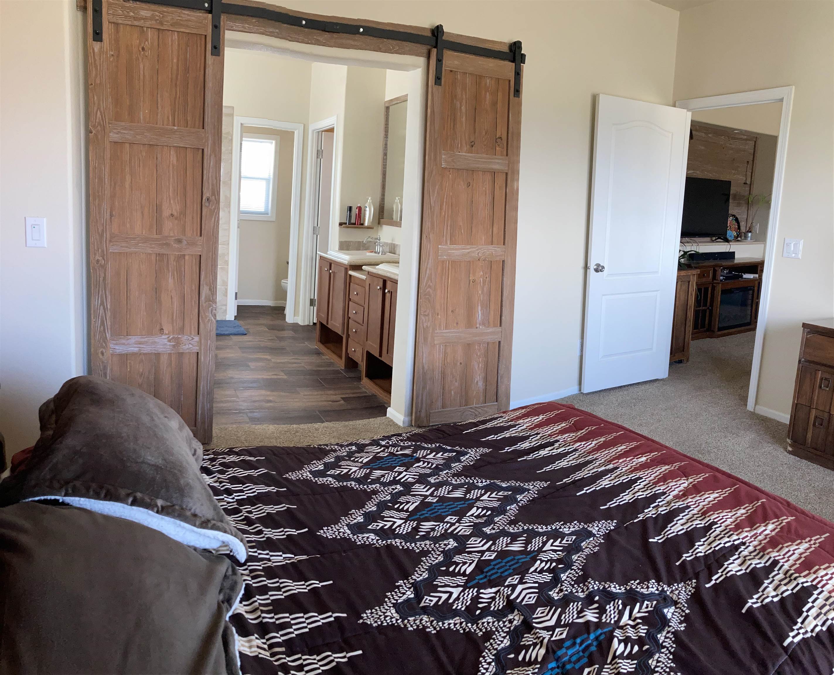 2413 1300th Road Delta, CO 81416 - Photo 14 of 35 a bedroom with a bed and wooden floor