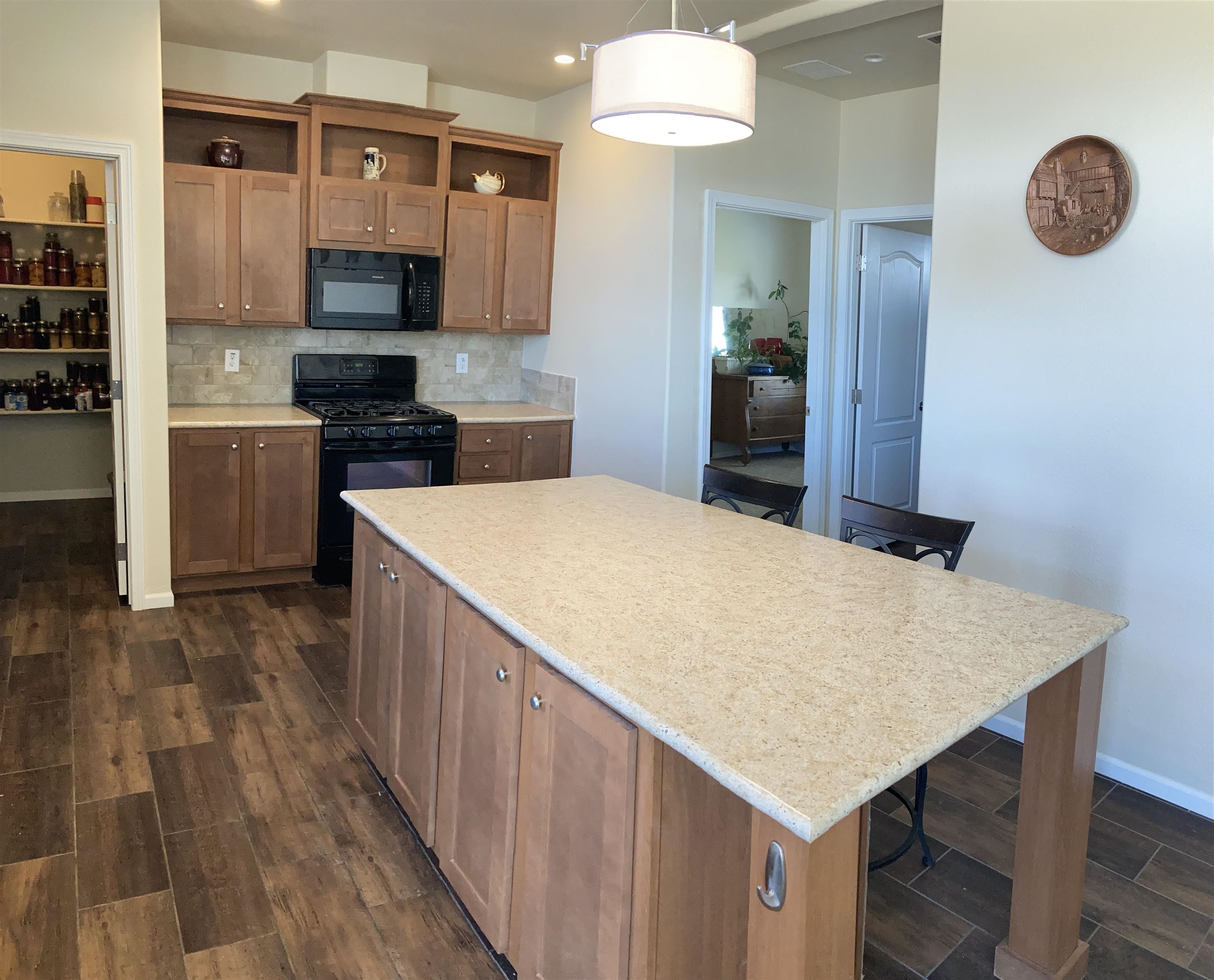 2413 1300th Road Delta, CO 81416 - Photo 9 of 35 a kitchen with kitchen island a counter space a sink and appliances