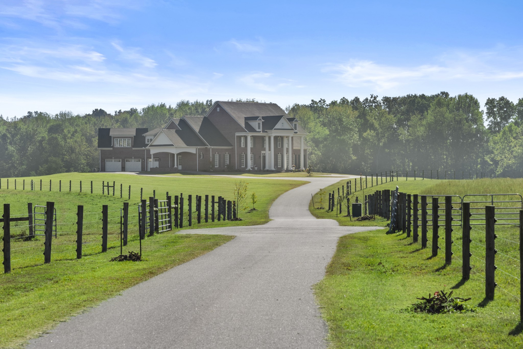 a view of a park with iron fence