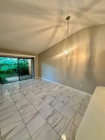 a view of a livingroom with a ceiling fan and window